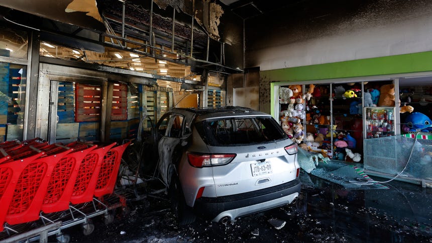 Un vehículo incendiado por presuntos integrantes del Cártel Jalisco Nueva Generación en un centro comercial en Guadalajara. 