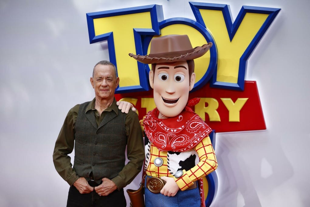 Antes de entrar al evento, Tom Hanks (voz de Woody) se asomó unos segundos por encima de una de las vallas que rodeaban el perímetro de la alfombra, desatando la locura entre los asistentes y los curiosos.